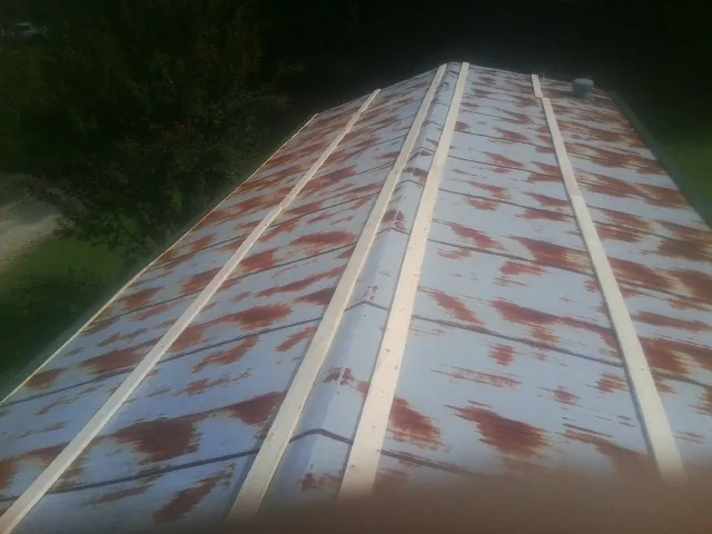 Rusted metal roof panels with new wood purlins before replacement — Storm Damage Roof Repair in Duryea by Roofing Brothers